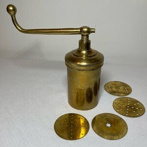Vintage JAMBOLI Brass food press. four inserts.
